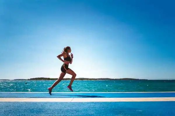 Woman running showing strong leg muscle Hinkley